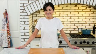 Selena Gomez standing in her kitchen