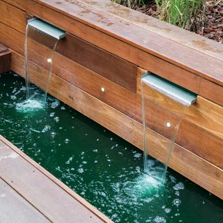 Wooden water feature in garden