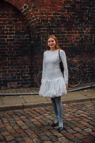 woman wearing bubble skirt dress, stockings, and heels