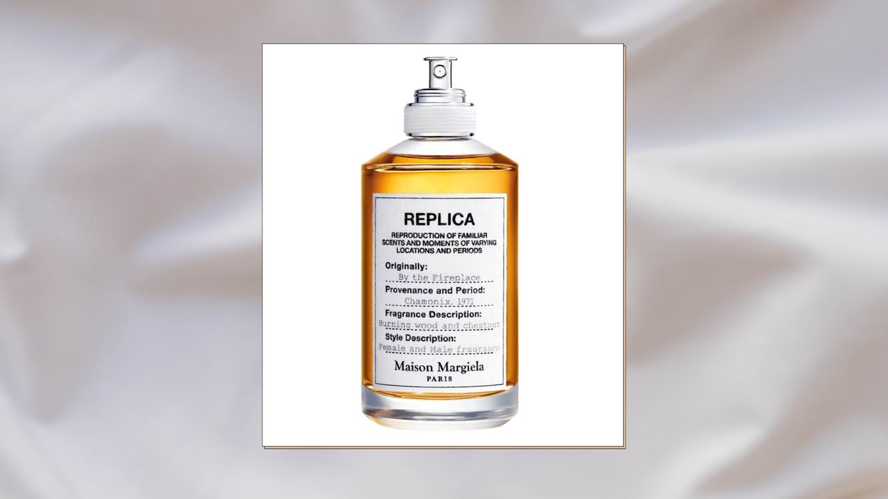 A close up of a bottle of Maison Margiela Replica By The Fireplace Eau de Toilette/ in a white linen bedsheet template