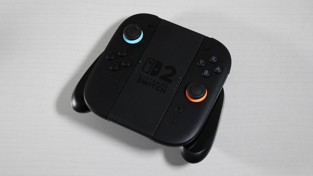 Nintendo Switch 2 Joy-Con 2 Grip lying on its back on a white desk.