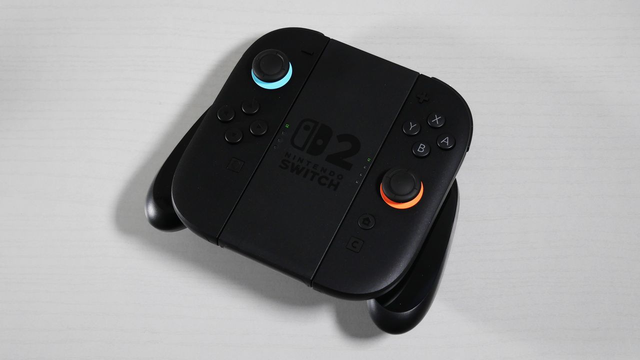 Nintendo Switch 2 Joy-Con 2 Grip lying on its back on a white desk.