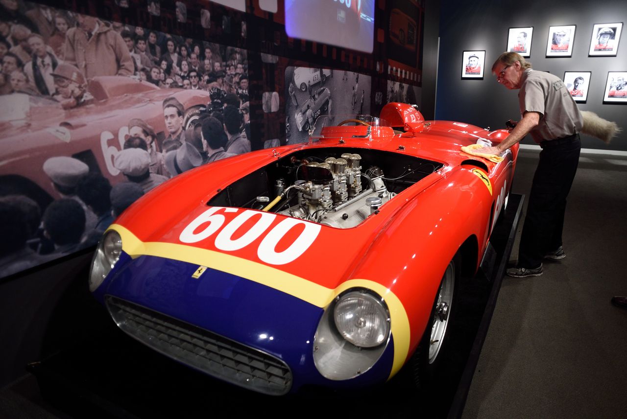 A Sotheby's employee dusts off the1956 Ferrari 290 MM by Scaglietti being exhibited at Sotheby's December 9, 2015 in New York. The car is to be auctioned December 10, 2015 during the Driven b