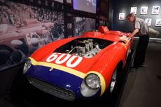 A Sotheby's employee dusts off the1956 Ferrari 290 MM by Scaglietti being exhibited at Sotheby's December 9, 2015 in New York. The car is to be auctioned December 10, 2015 during the Driven b