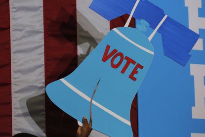 A sign depicting the Liberty Bell with the word "vote."
