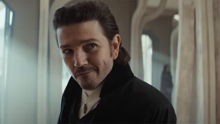 Cassian raising a wry smile as he checks into a hotel on Ghorman in Andor season 2