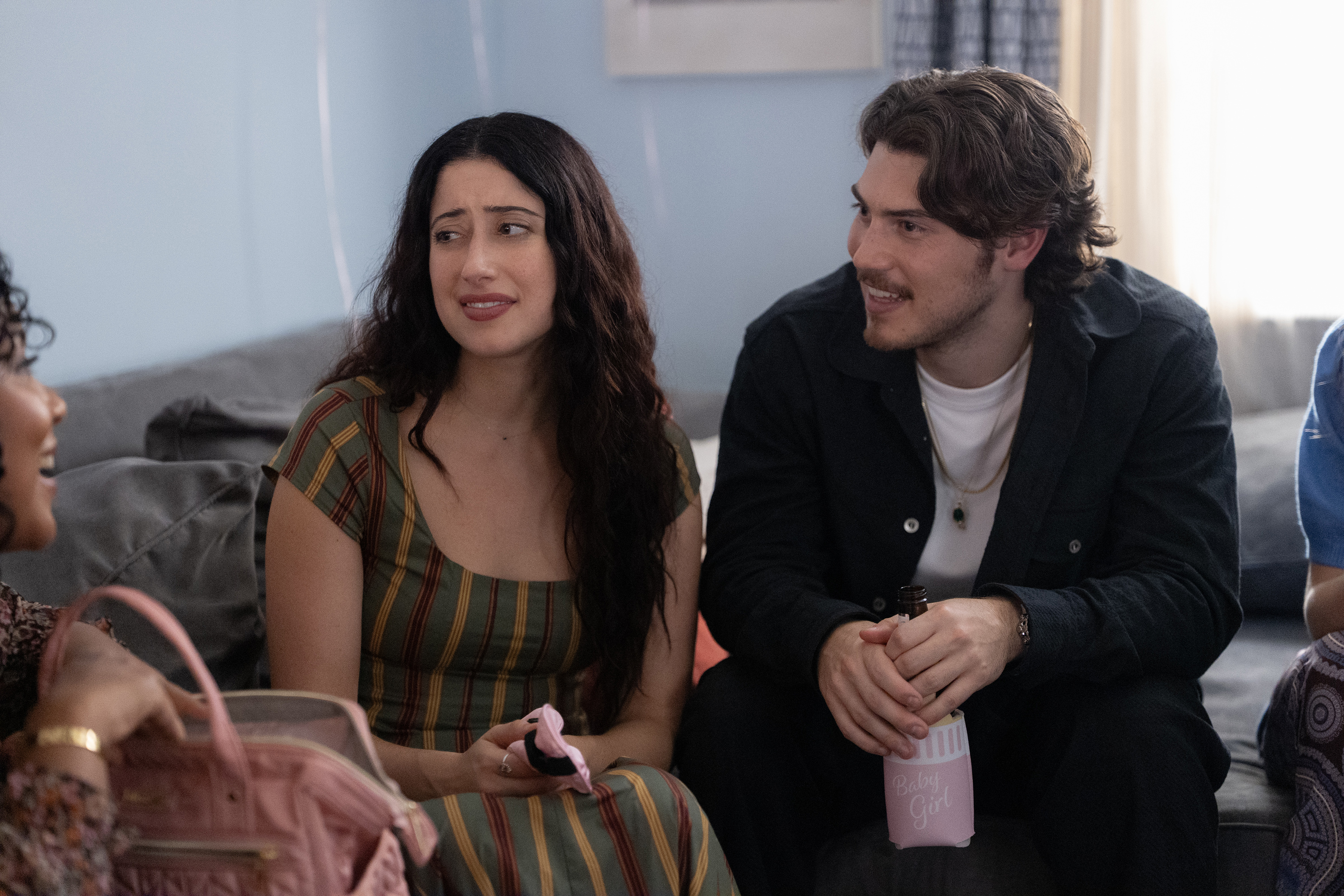 Taylor Ortega as Morgan and Jack Innanen as Max, sitting on a couch during a baby shower in Episode 106 of BIG MISTAKES.