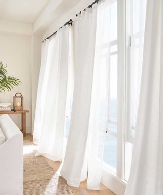 Pottery Barn white curtains in a neutral living room