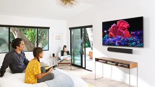 People in a living room watching a Vizio TV.
