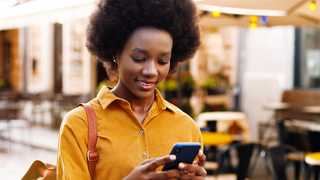 Lady in town using phone