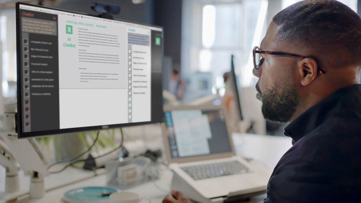 A black man sat at a computer, using ChatGPT