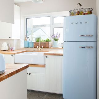 blue smeg fridge freezer in light and bright kitchen