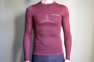 A man wearing a burgundy Van Rysel racing base layer