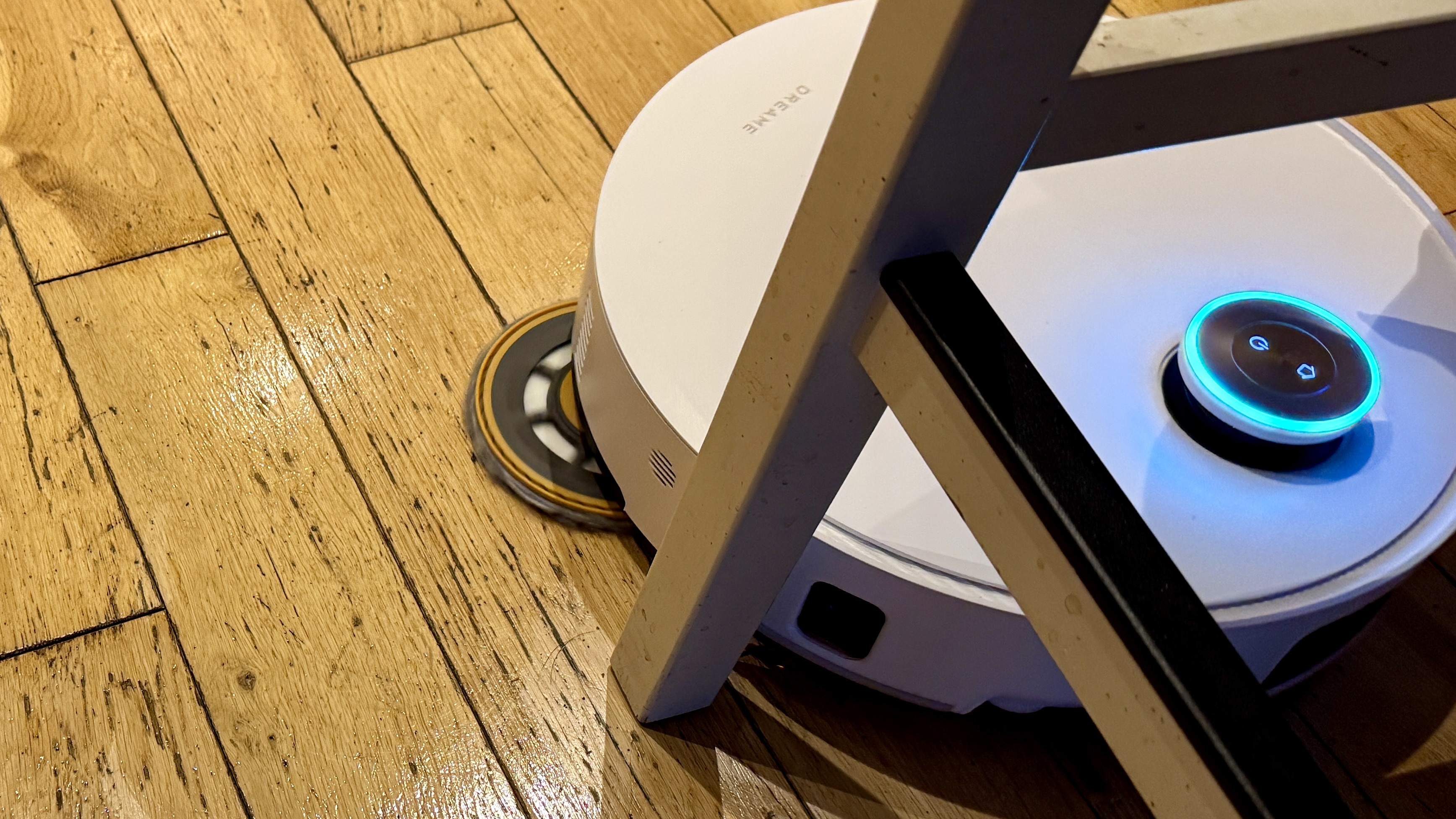 Dreame Matrix10 Ultra robot vacuum mopping a wooden floor, with mop pad extended
