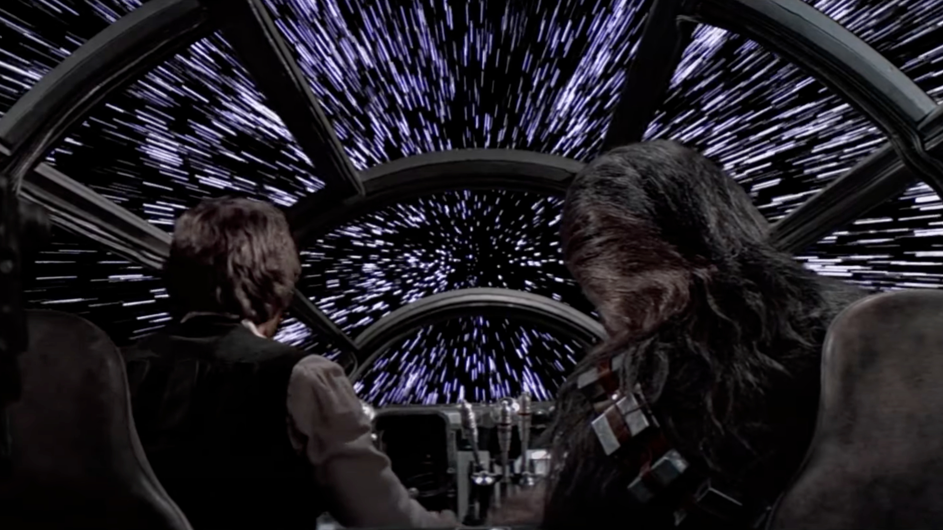 Han Solo and Chewbacca in the Millennium Falcon as it jumps to hyperspace.