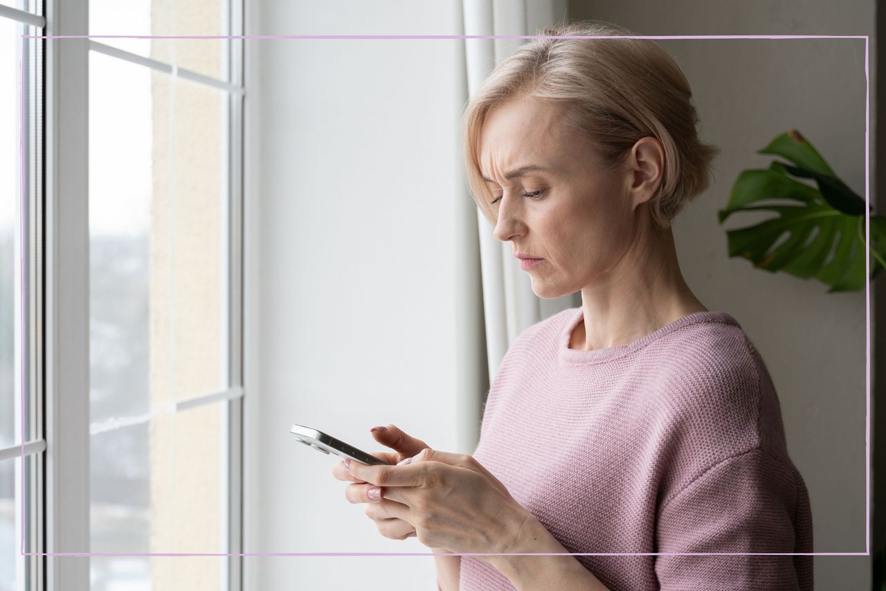 Woman looking at her phone with concern