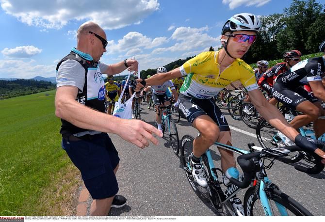 Race leader Tony Martin picks up his lunch