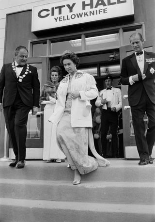 Queen Elizabeth II wears her aquamarine tiara with a long evening dress and a fringed cowboy jacket to leave Yellowknife City Hall during a royal tour of Canada, July 1970