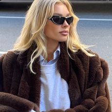 Elsa Hosk wearing a fur coat and sweatpants.