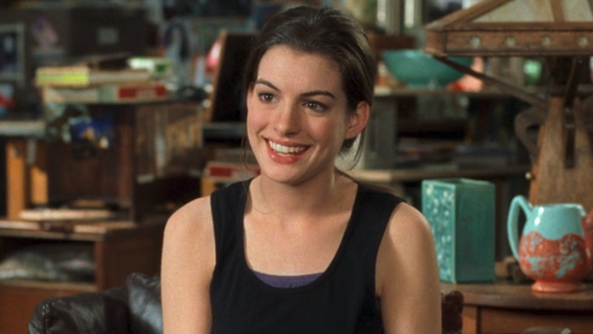 Anne Hathaway smiling as Mia Thermopolis with a tank top on in The Princess Diaries
