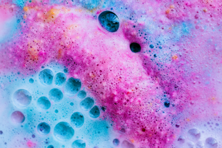 Pink and blue bath bomb dissolved in water