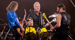 Metallica huddle around Lars Ulrich on drums