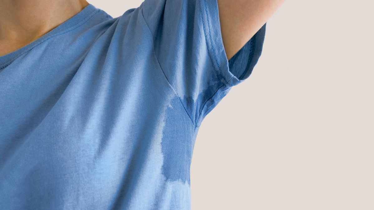 Man with sweat stain on T-Shirt