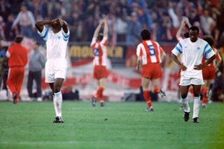 Marseille players look dejected following their defeat in the 1991 Champions League final as Red Star Belgrade players celebrate victory.