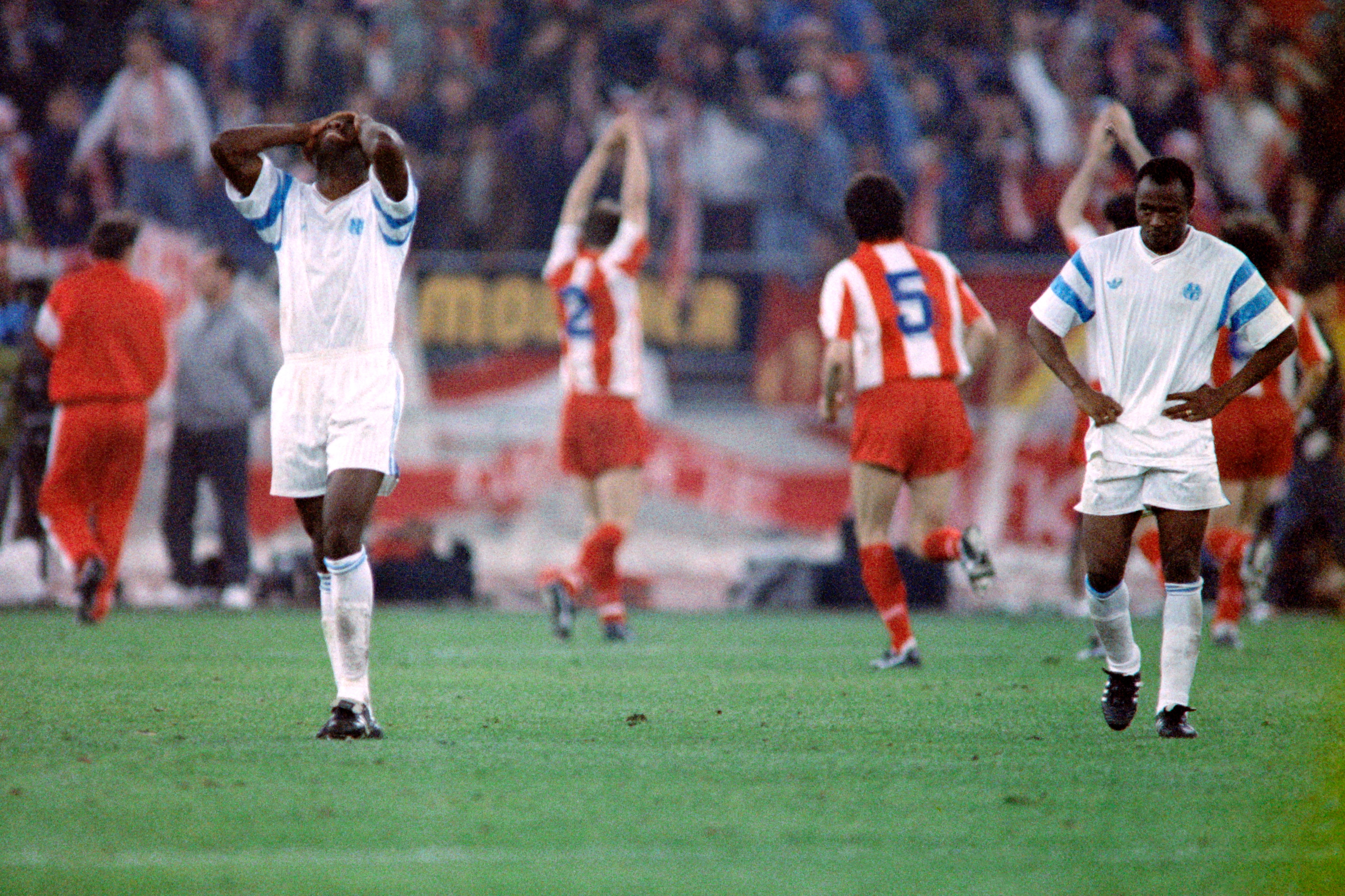 Marseille players look dejected following their defeat in the 1991 Champions League final as Red Star Belgrade players celebrate victory.