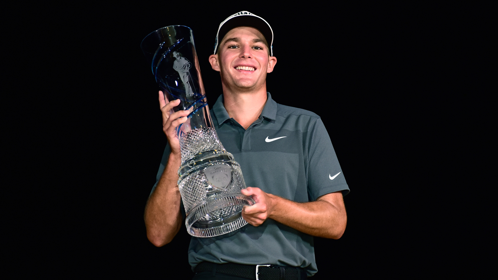 Aaron Wise holds a trophy