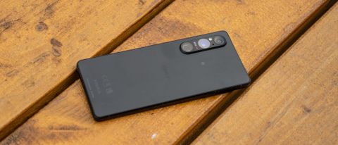 A black Sony Xperia 1 V camera phone sitting on a wooden table