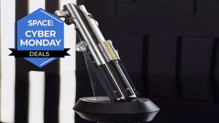 Skywalker legacy lightsaber on a plastic plinth with a black background and a space.com cyber monday deals logo in the top left
