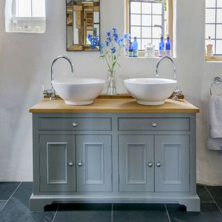 bathroom with white wall white wash basin and blue drawer