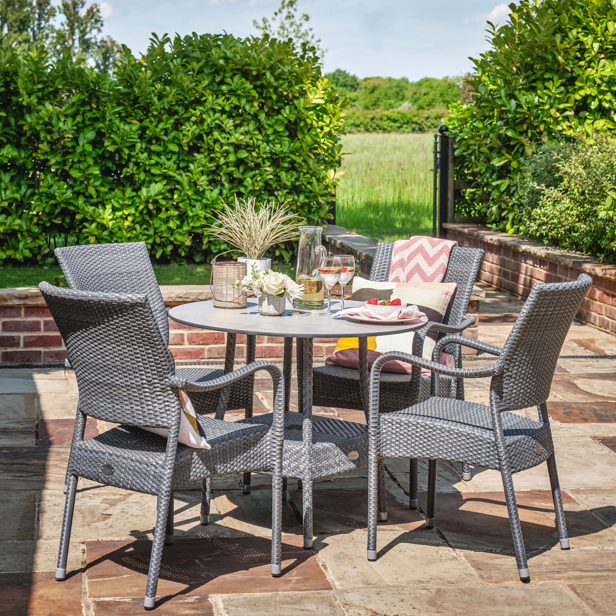 Patio furniture in small garden of four chairs and dining table