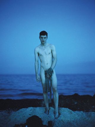 Naked man by sea