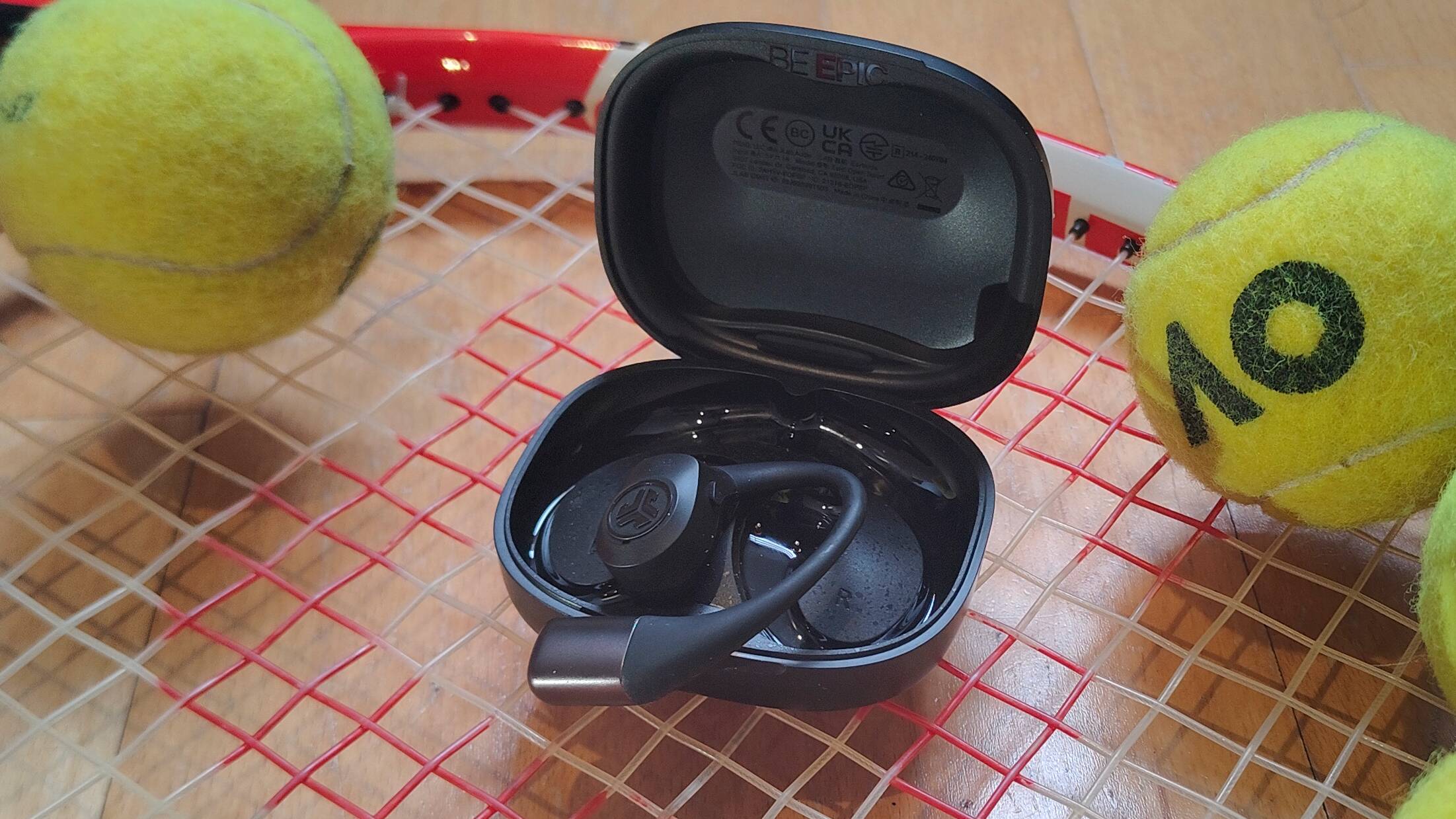 The JLab Epic Open Sport on a tennis racquet.