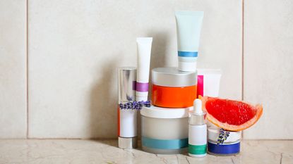 skincare prodcuts stacked in bathroom