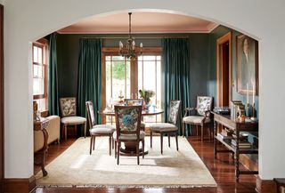 A living room with a painted ceiling in pink, and walls in green