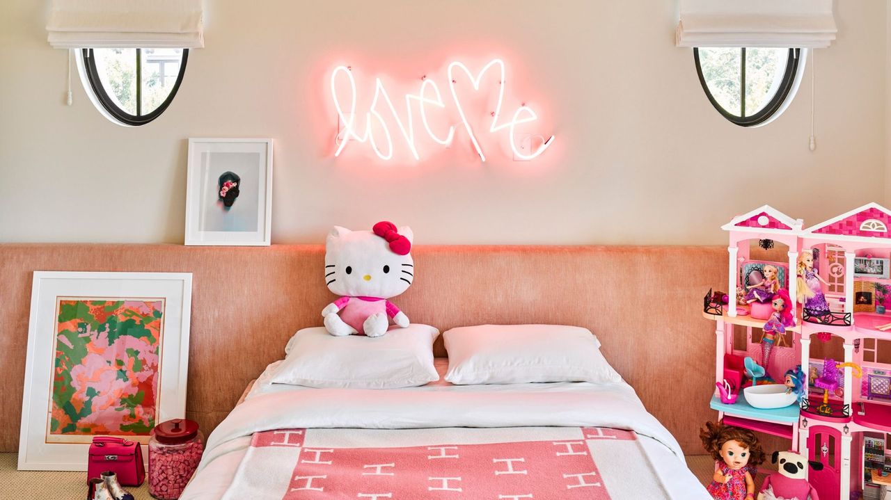 pink kids&#039; bedroom with oversized pink headboard