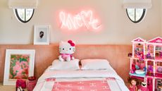 pink kids' bedroom with oversized pink headboard