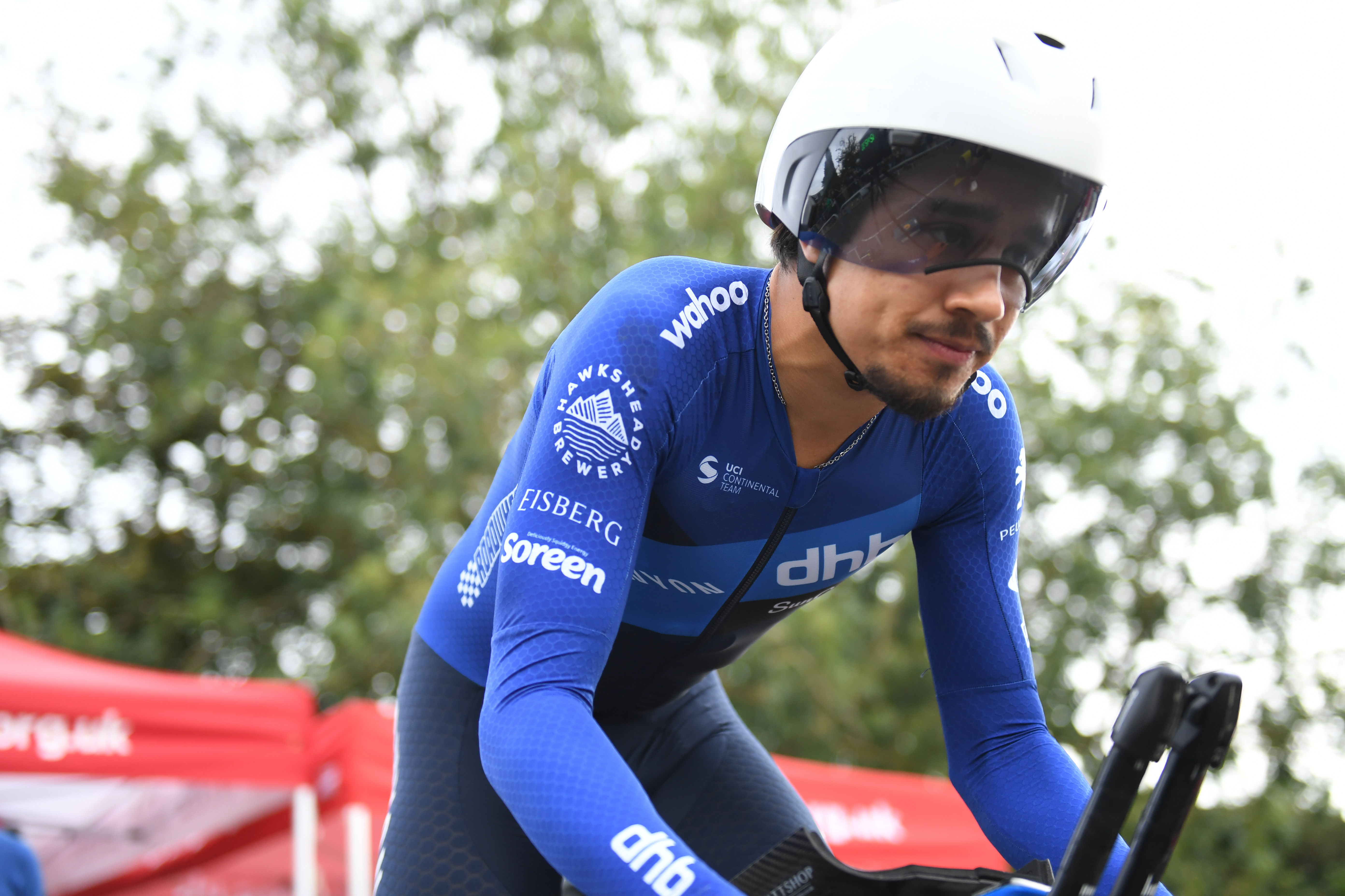 Man cycles in blue jersey and white helmet