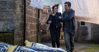 Cain Dingle finds Emma Barton in Holly’s room and orders her out but she just ignores him. He’s certain she’s up to no good and drags her outside. Shocked Moira Dingle reveals she had asked Emma to pack up Holly’s clothes and Cain realises he’s been played and is forced to walk away in Emmerdale.