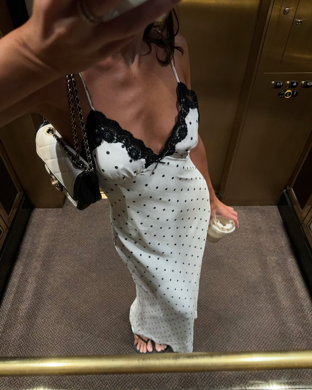 woman wearing polka dot dress and chanel bag