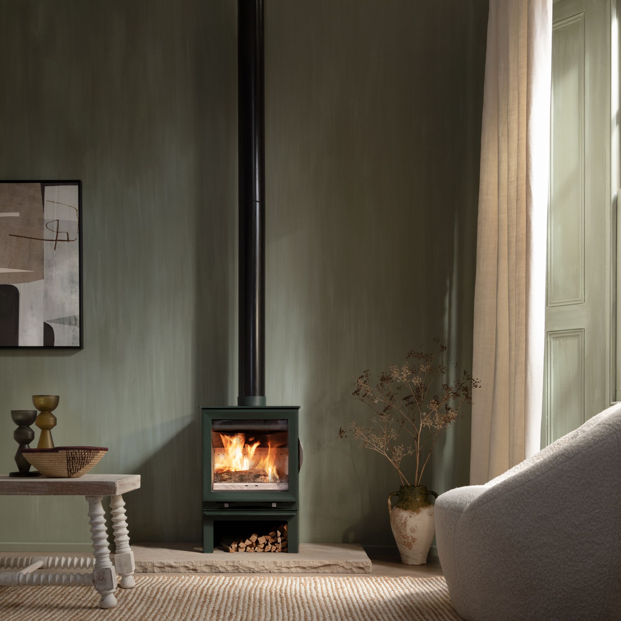 Arada Earth log burning stove in pine in a room setting