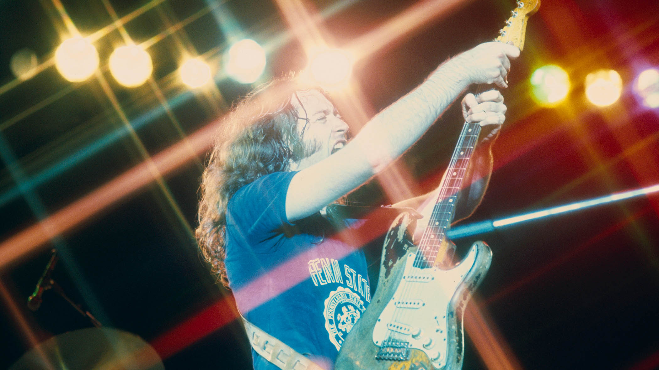 Rory Gallagher gives his Stratocaster the treatment during a live performance in 1975.