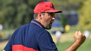 Scottie Scheffler fist pumps after winning the 15th hole in his Ryder Cup singles match against Jon Rahm