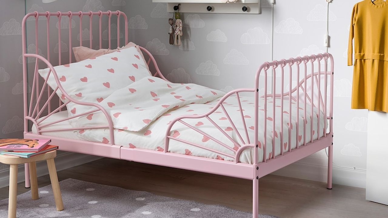 Pink bed frame with heart-patterned bedding