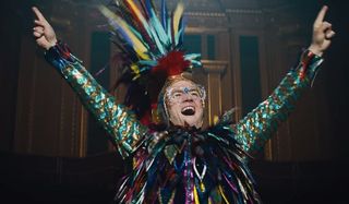 Rocketman Elton hamming it up on stage in a bird-like costume