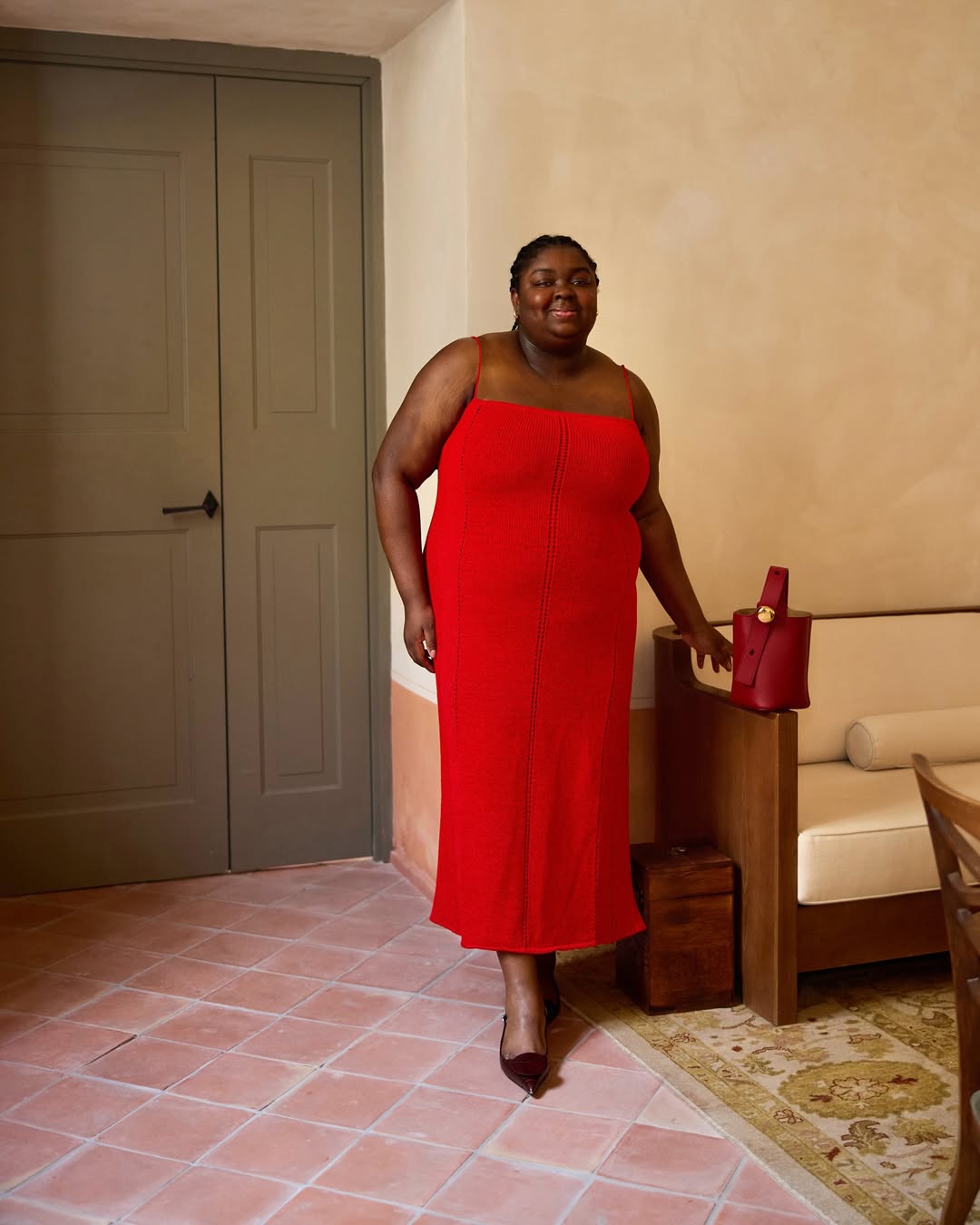 Abisola in a red knit dress