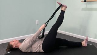 Nicki Evans performs hamstring and hip stretch